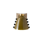 Green glass shade with a gold cap and black studs, photographed straight on against white; a Clérachic wall light.