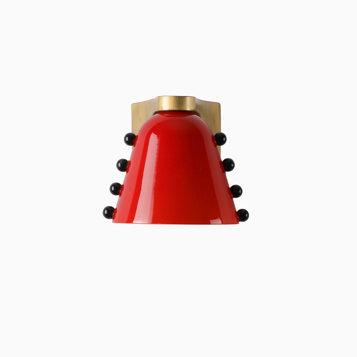 The red glass version of this Clérachic wall light, with black studs on both sides and a gold cap and bracket.