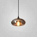 Clérachic hand-blown smoked glass pendant with a wide flattened disc shade, lit and hung on a black cord.