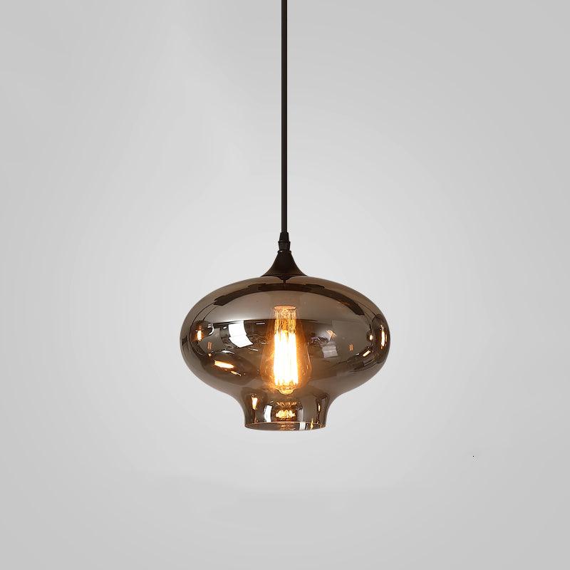 Onion-shaped Clérachic smoked glass pendant with a flared open foot, lit by a warm teardrop filament bulb.