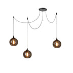 Three globe Clérachic smoked glass pendants from a single spider canopy, cords fanning out to three drop points.