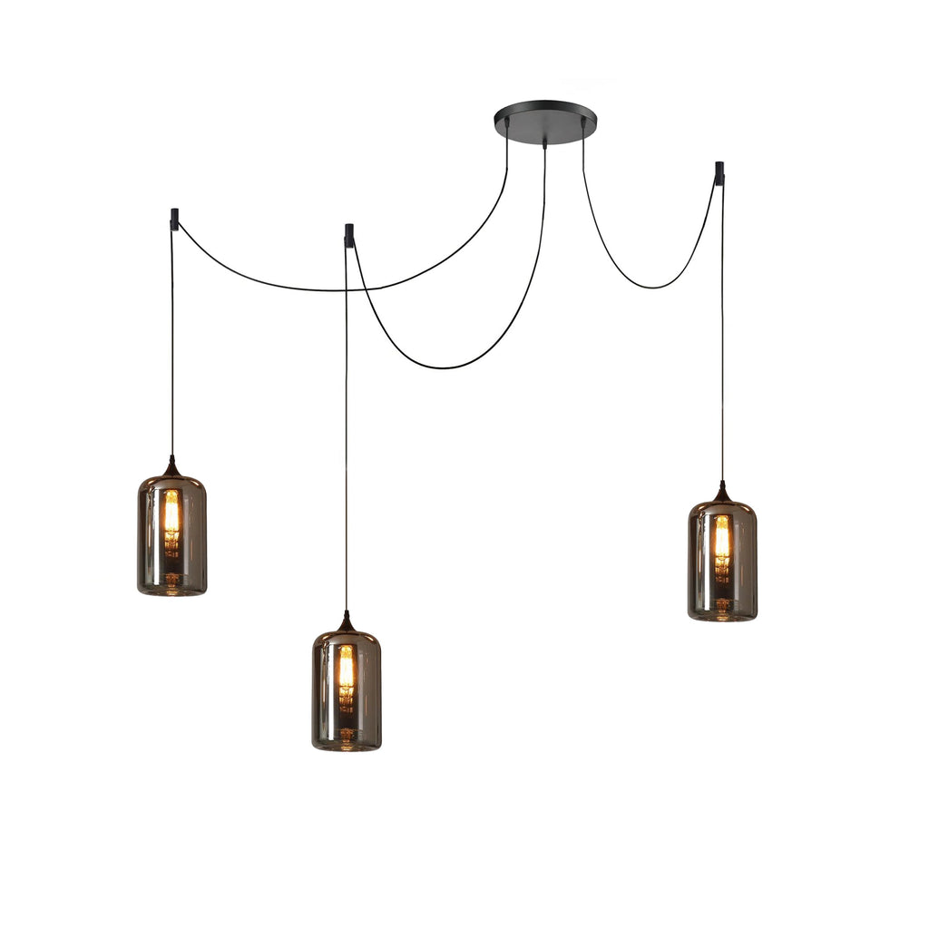 Three cylindrical Clérachic smoked glass pendants swagged from one canopy, each lit by an upright bulb.