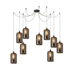 Nine cylindrical Clérachic smoked glass pendants hung in a deep cluster from a single round canopy.