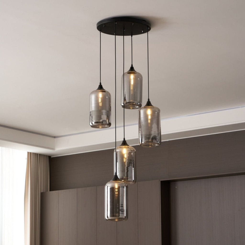 Round black canopy carrying five Clérachic smoked glass cylinders beside a curtained window.