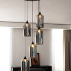 Clérachic smoked glass cylinder cluster in a bright sitting room, sheer curtains behind the lit shades.