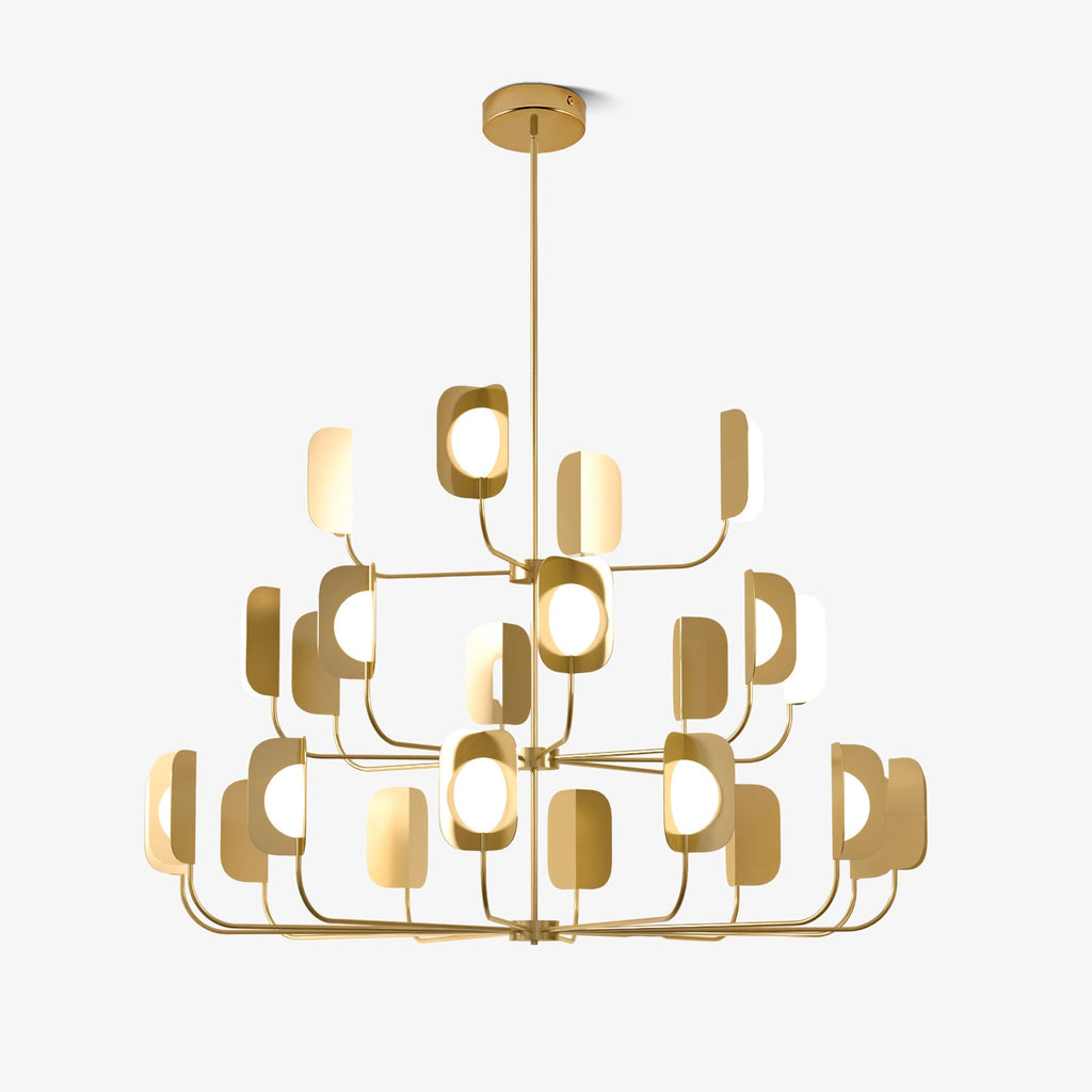 Three tiers of slim arms hold leaf-shaped shades round glowing globe bulbs on this brass-toned Clérachic chandelier, on a plain white backdrop.