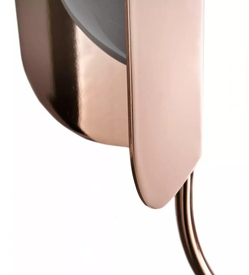 Close view of a copper leaf shade with a gently curved lip and a slim arm, on a white backdrop, part of this Clérachic chandelier family.