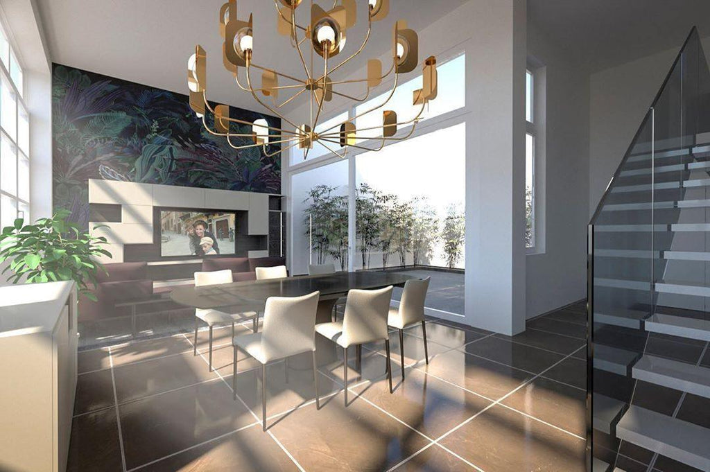 A brass-toned Clérachic chandelier in a visualisation of a stairwell room with large windows, a dining table and a dark tiled floor.