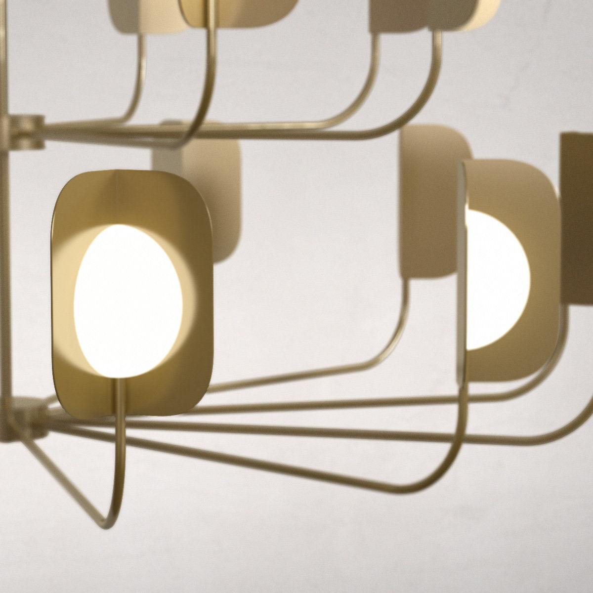 Close view of lit globes inside brass-toned leaf shades on a Clérachic chandelier, with a tier of slim arms beneath.