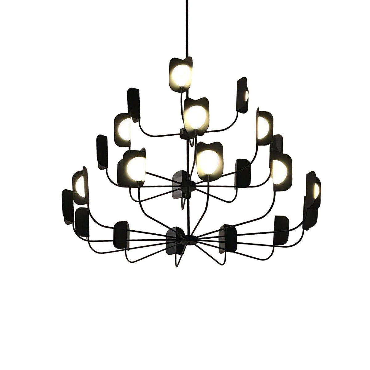 A black three-tier Clérachic chandelier lit against a white backdrop, with fine curved arms, leaf shades and globes.