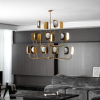 The same brass-toned Clérachic chandelier lit in the dark-panelled lounge, shown at a slightly lower angle with a curtain at left.