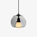 A Clérachic pendant with a smoke glass orb that nests a frosted bulb, hung from a black cord on a plain white backdrop.