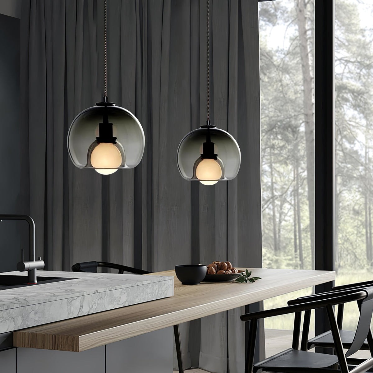 Two smoke glass Clérachic pendants hang beside tall grey curtains over a stone counter in a forest-view room.