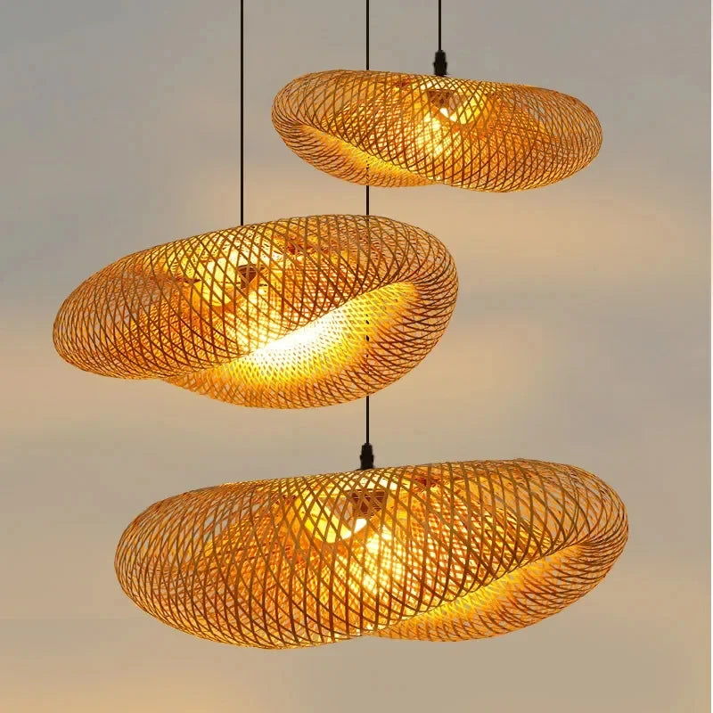 Three Clérachic bamboo pendants lit at different drops against a warm gradient background.