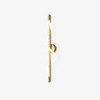 A Clérachic wall light with a slim brass rod and a glowing white silicone band twisting around it, on a white backdrop.