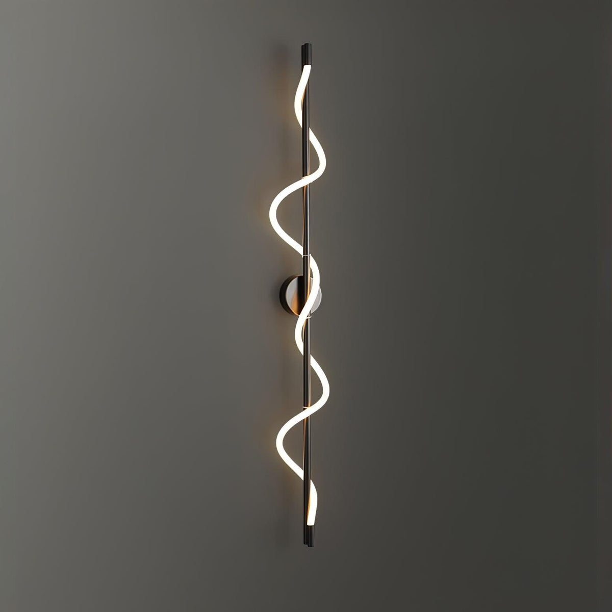 Glowing on a dark grey wall, a black Clérachic wall light with a two-turn spiral band and a round backplate.
