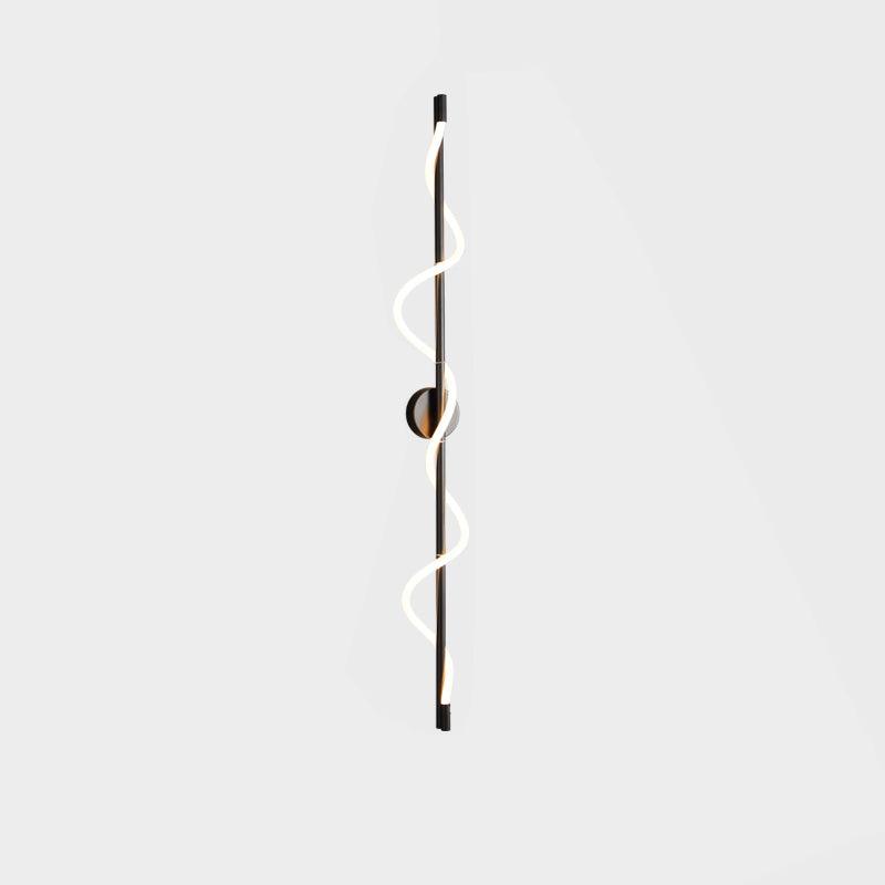 A tall black Clérachic wall light with a lit two-turn spiral band and a round backplate, on a pale backdrop.