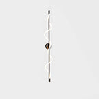 A tall black Clérachic wall light with a lit two-turn spiral band and a round backplate, on a pale backdrop.