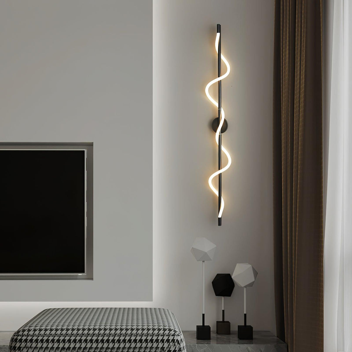 A tall black Clérachic wall light with a glowing spiral band hangs by a wall-mounted screen above a houndstooth throw.