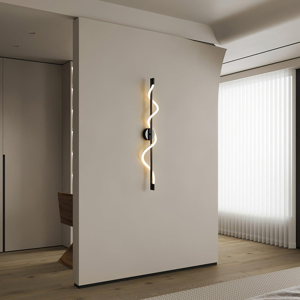 In a hallway with vertical blinds, a black Clérachic wall light with a lit spiral band hangs on a cream wall.
