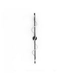 A black Clérachic wall light with a spiral band, shown unlit and white, on a white backdrop with a round backplate.