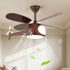 Dark walnut-toned helicopter ceiling fan from Clérachic with its light on, with leaves in the airflow and a pale wardrobe wall behind.