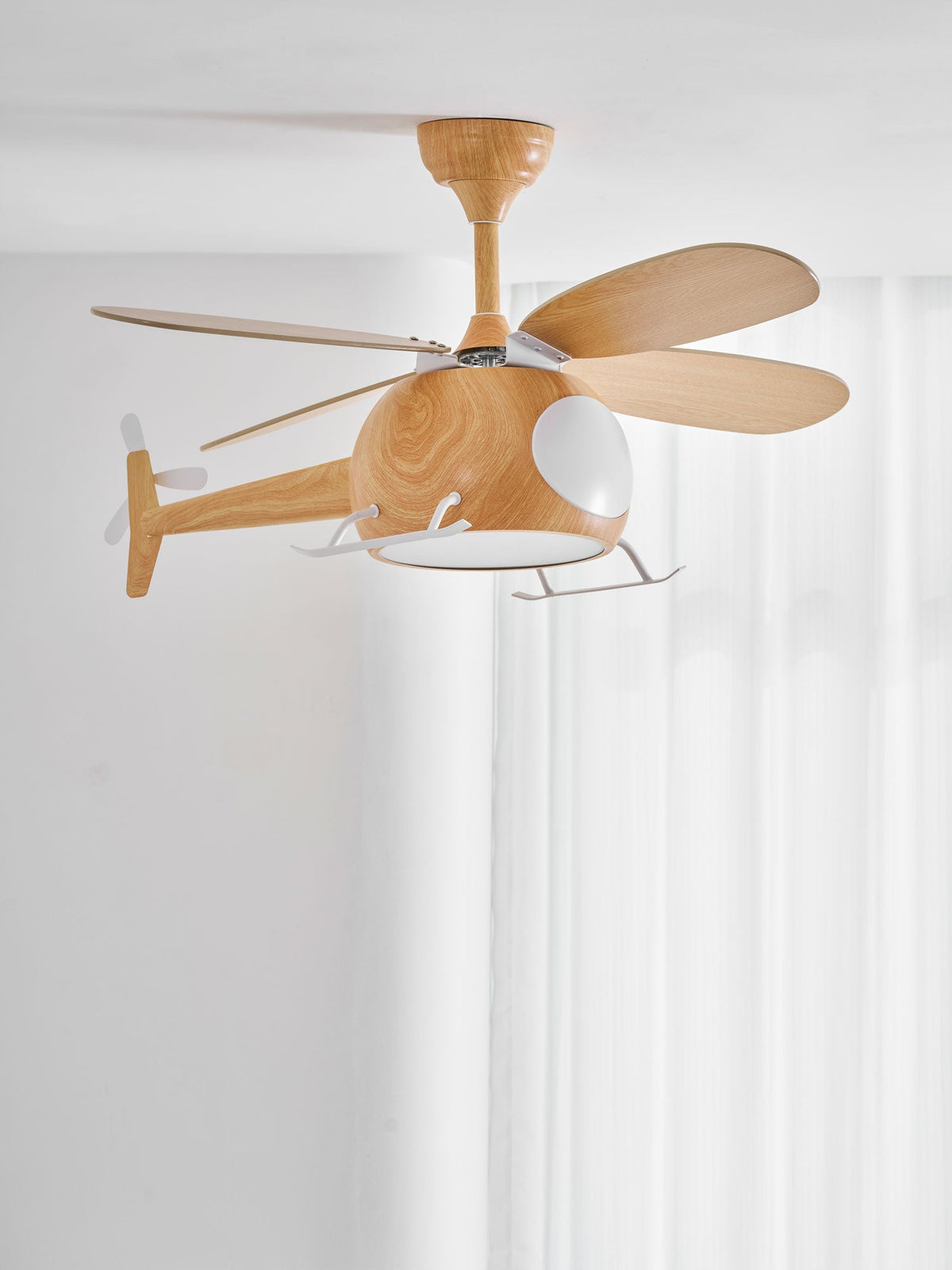 The Clérachic helicopter fan seen from the side, with its lit cabin, four wood-grain blades and tail rotor against sheer white curtains.