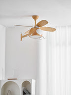 Helicopter ceiling fan from Clérachic seen from slightly below against sheer curtains, with the edge of an arched white shelf at the bottom.