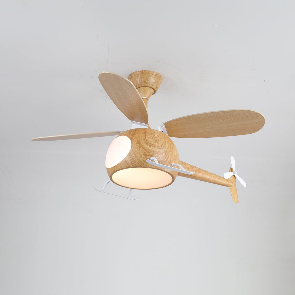 A warm light is on under the cabin of this wood-grain Clérachic helicopter fan, with its four blades spread wide.