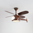 The walnut-toned Clérachic helicopter ceiling fan with a warm light glowing under the cabin, against a grey ceiling.