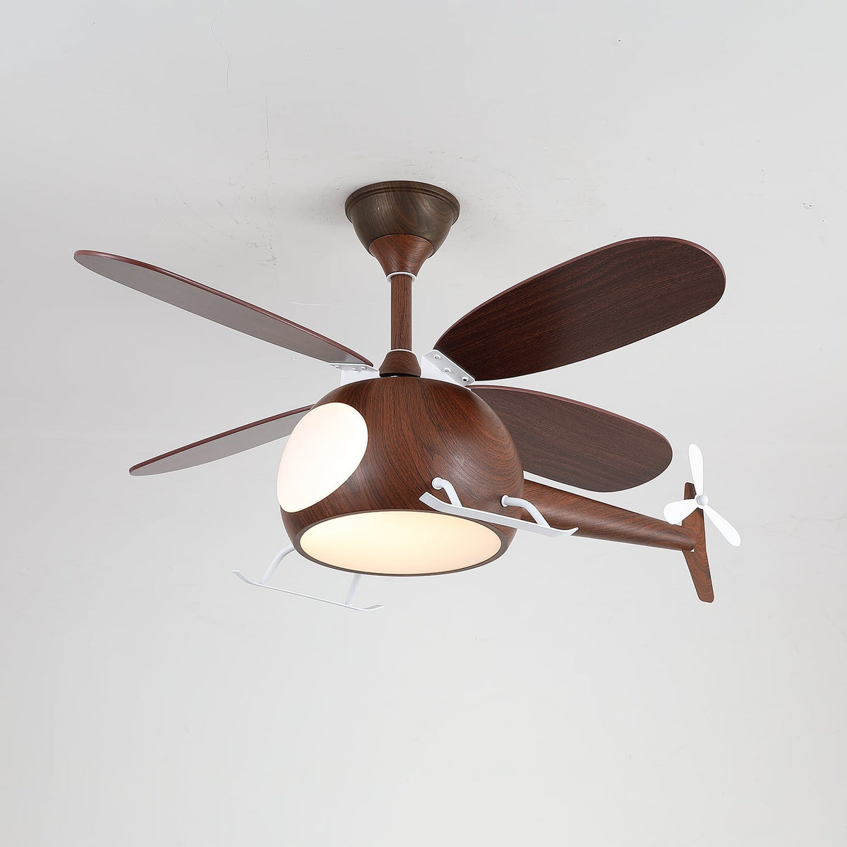 A walnut-toned helicopter ceiling fan from Clérachic with a warm light on, its four dark blades spread against a grey ceiling.