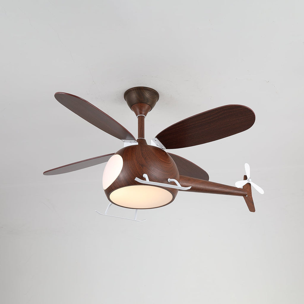 Dark walnut-toned helicopter ceiling fan from Clérachic with its light on, seen from a low angle against a light grey ceiling.
