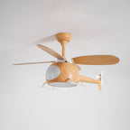 At an angle, a wood-grain Clérachic helicopter fan with its cabin light off and one blade pointing sideways.