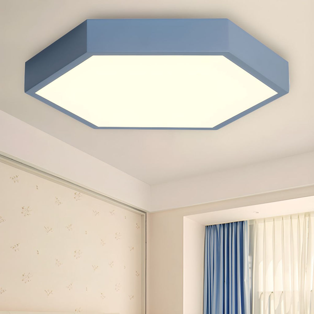 Blue Clérachic hexagon ceiling light mounted flush above a bedroom corner with floral wallpaper and drapery.