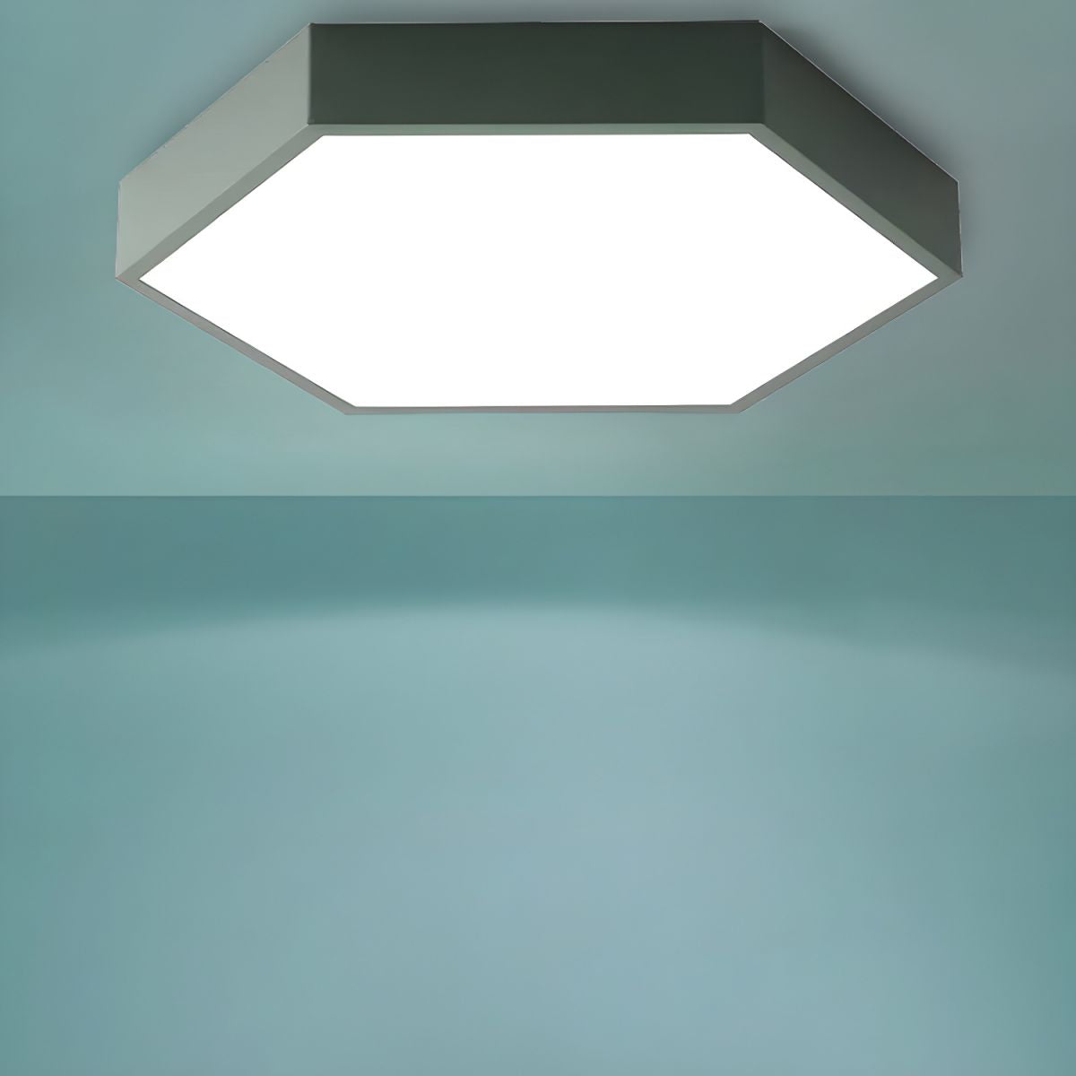 Sage-green Clérachic hexagon LED ceiling light shown alone against a plain teal studio backdrop.