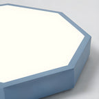 Close-up of the blue-gray Clérachic hexagon ceiling light's beveled corner and acrylic diffuser panel.