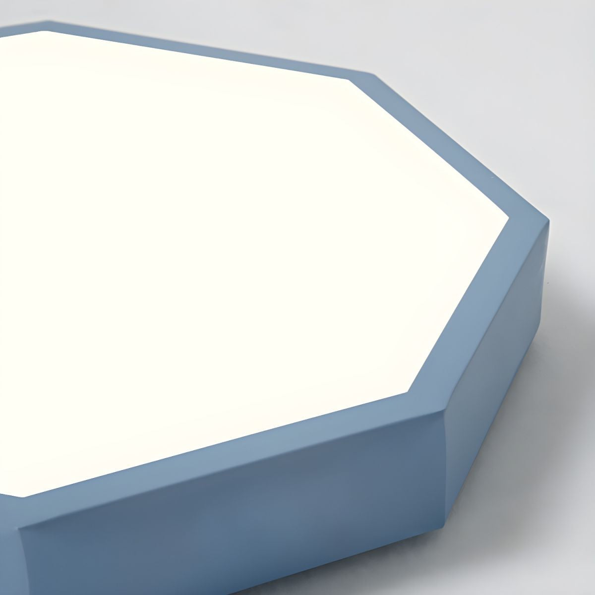 Close-up of the blue-gray Clérachic hexagon ceiling light's beveled corner and acrylic diffuser panel.