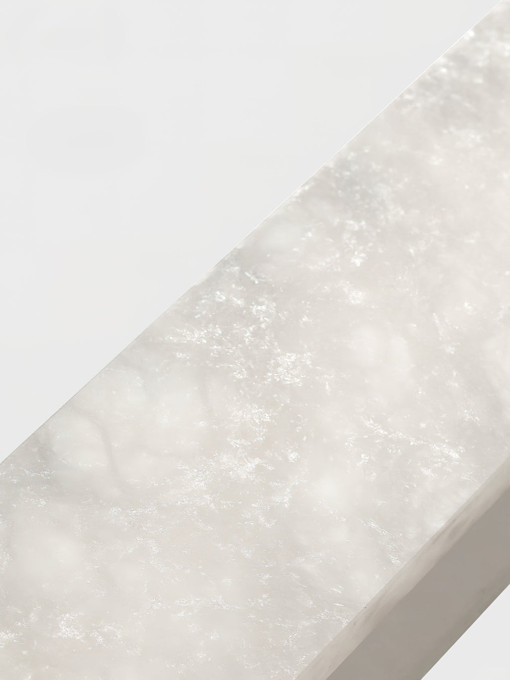 Close crop of a Clérachic Hexagonal Alabaster Chandelier bar, showing the cloudy veining running through the Spanish stone.