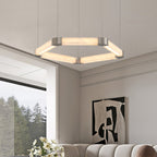 Clérachic Hexagonal Alabaster Chandelier glowing warm above a living room with a curved sofa and a wide forest window.