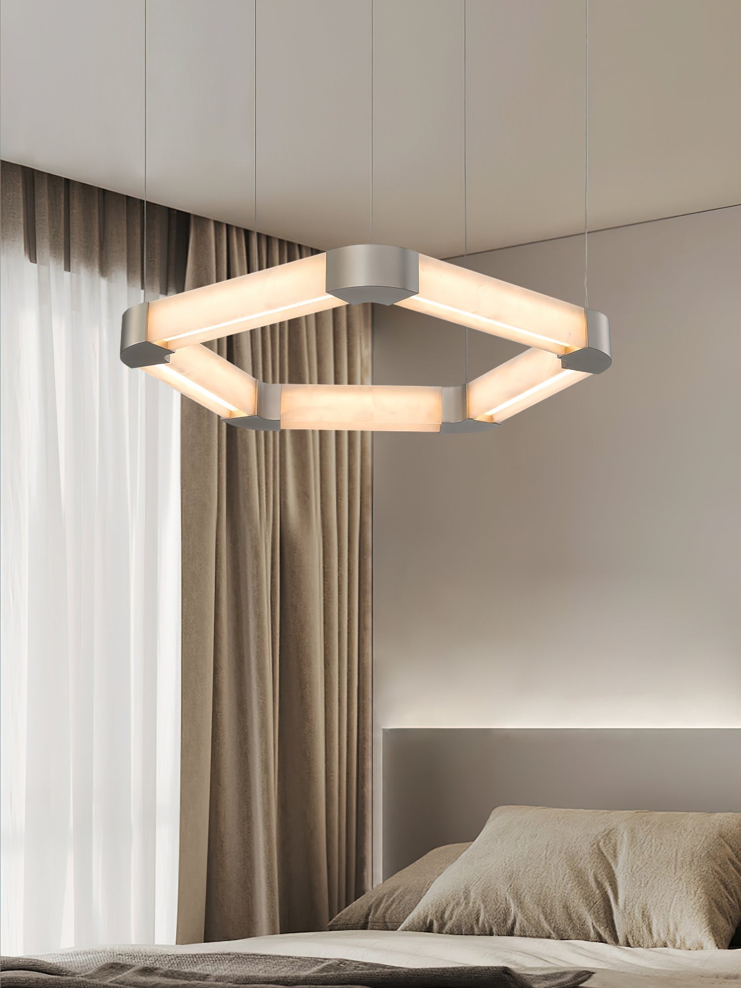 Clérachic Hexagonal Alabaster Chandelier lit over a bed, its warm frame picked out against linen curtains and soft walls.