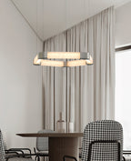 Clérachic Hexagonal Alabaster Chandelier over a dining table with houndstooth chairs, the lit hexagon clear of the tabletop.