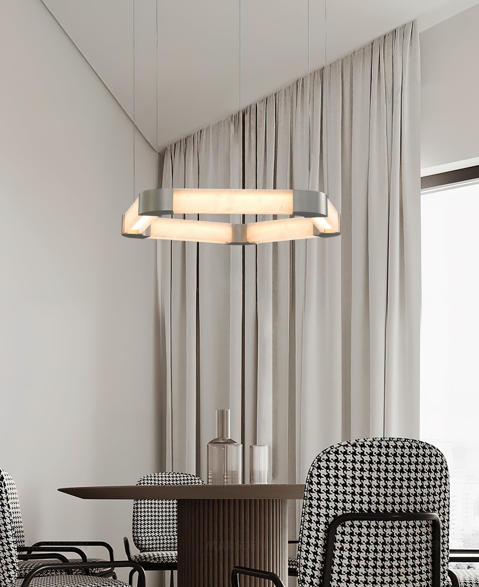 Clérachic Hexagonal Alabaster Chandelier over a dining table with houndstooth chairs, the lit hexagon clear of the tabletop.