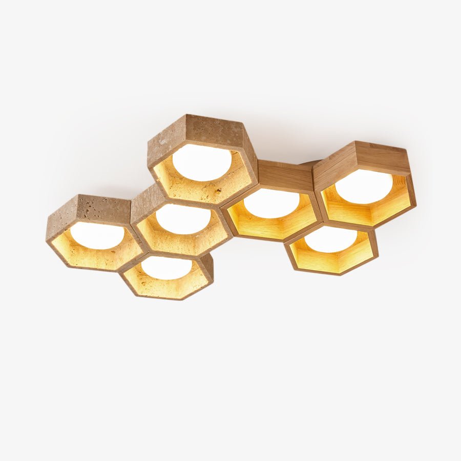 Cluster of seven hexagonal travertine and wood ceiling lights, all lit, on a plain white backdrop, from Clérachic.