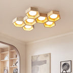 Hexagon cluster of this Clérachic ceiling light glowing amber above a hallway with an arched opening and built-in shelves.