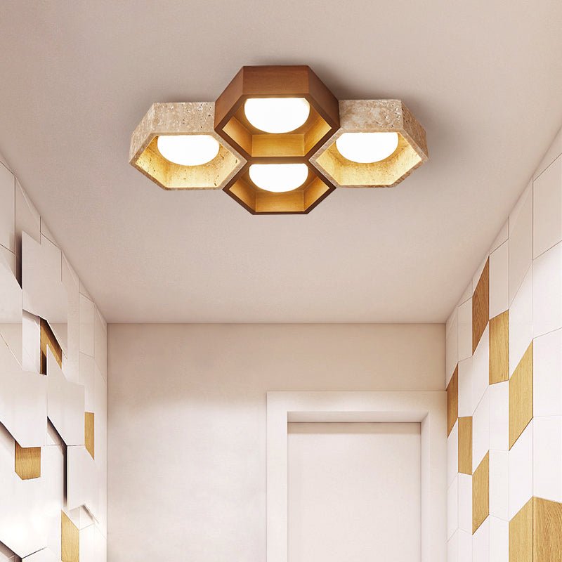 Four-cell Clérachic ceiling light with a dark walnut centre hexagon, above a hallway with geometric wood and white wall panels.