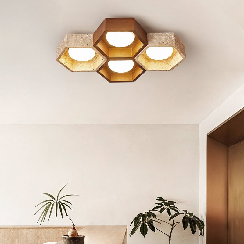 Compact four-hexagon Clérachic ceiling light with a walnut-tone cell, glowing above a room with a pot plant and low wooden console.