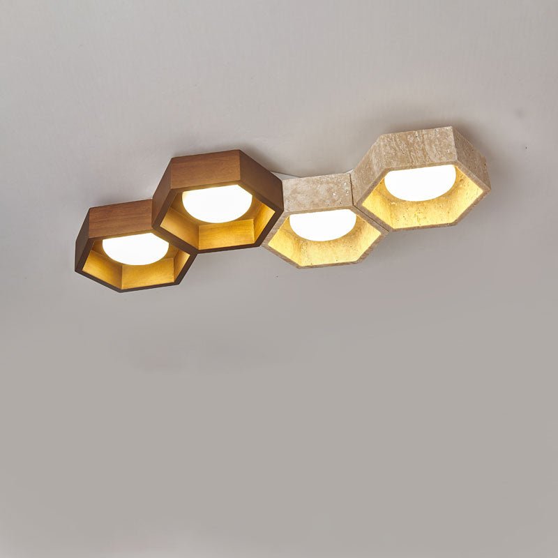 Four hexagons in a diagonal row, two walnut-toned and two travertine, on this Clérachic ceiling light against grey.