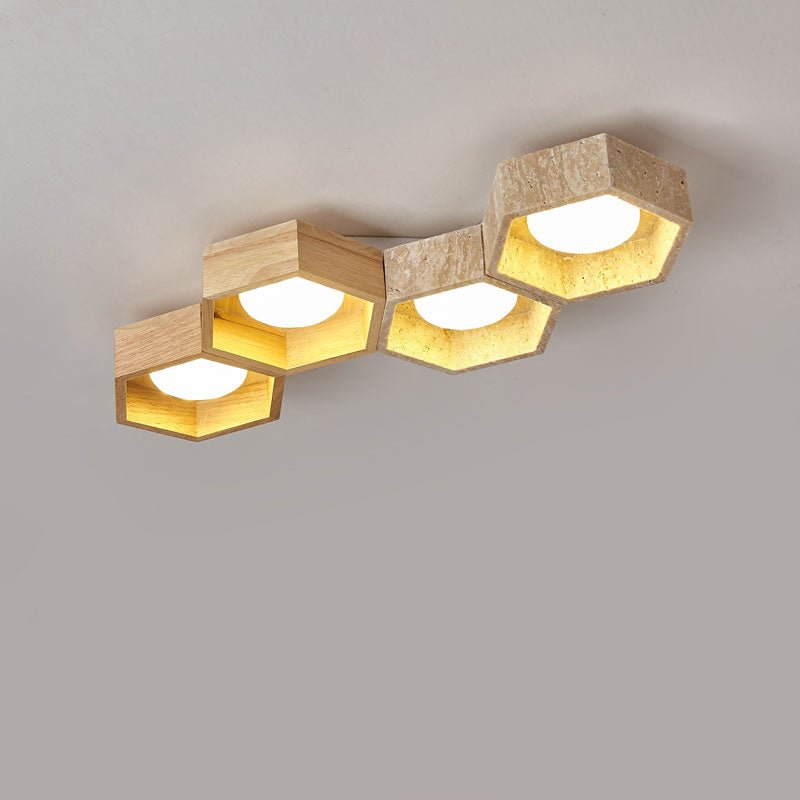 Four staggered hexagons in a stepped line, a Clérachic ceiling light with travertine and wood frames glowing on a grey ground.
