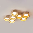 Seven-cell Clérachic ceiling light in an offset honeycomb arrangement, travertine and wood frames lit from within, on grey.