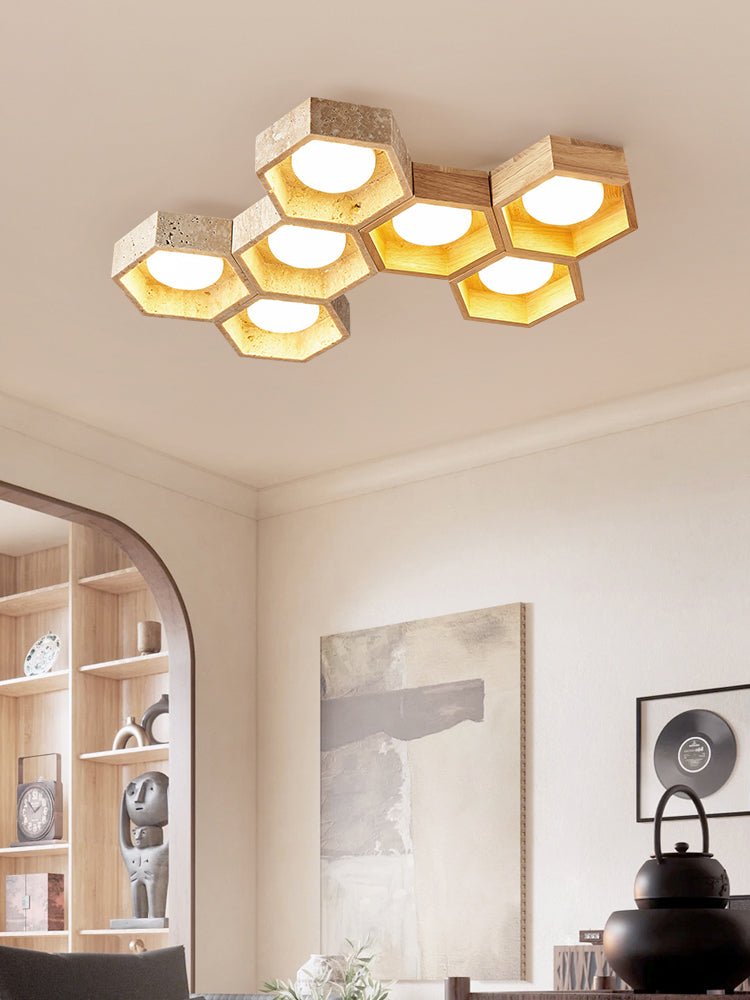 Seven-cell Clérachic ceiling light above a shelving alcove with an arched opening, a black teapot and a framed print in view.